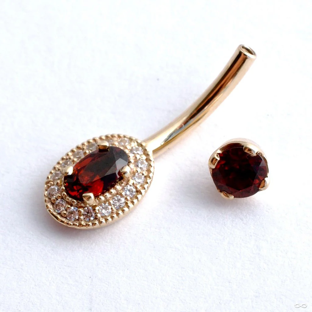 Oval Halo Curved Barbell in Gold with Garnet & Clear CZ from BVLA - Image 3
